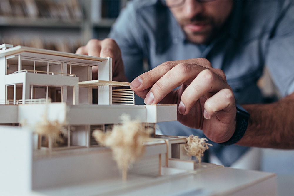 An architect builds a model building.