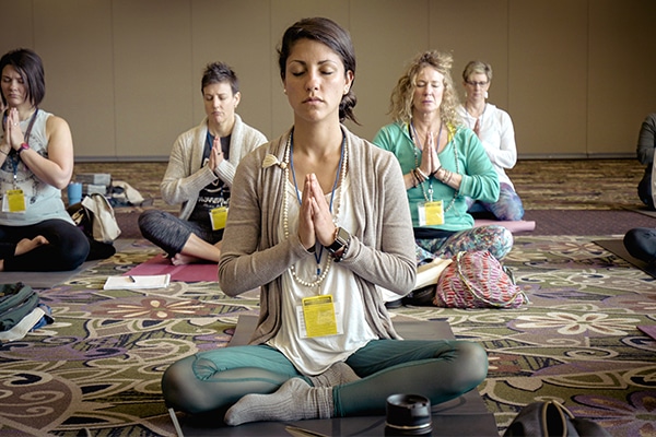 A yoga instructor has a class in a public building with the safety of yoga teacher insurance.