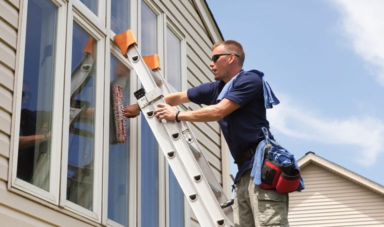 Man cleaning house windows
