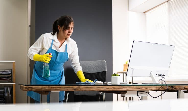 a woman cleaning a desk
