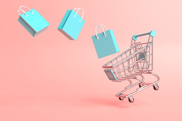 shopping cart and products with manufacturers insurance on a pink background.