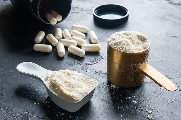 Powder and pill supplements are displayed for a product photo.