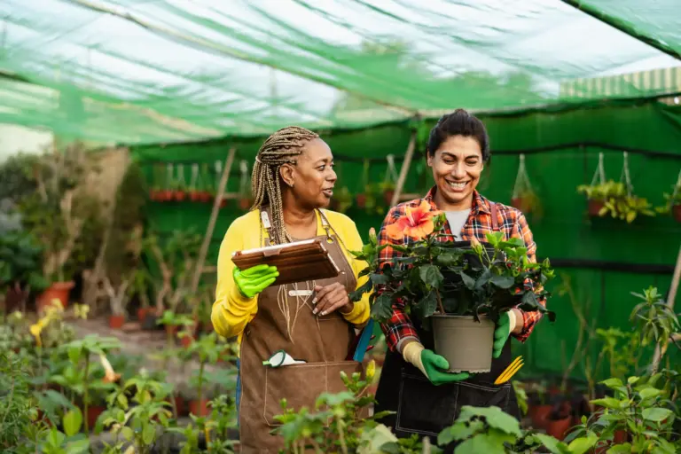 Two Women employees standing in a greenhouse